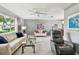 Comfortable living area showcases natural light, sleek sofas, and a ceiling fan at 2418 Cardwell Way, Sarasota, FL 34231