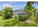 The screened-in pool area is enhanced by surrounding lush landscaping and green space at 2418 Cardwell Way, Sarasota, FL 34231