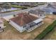 Aerial view of the home with a screen lanai and manicured backyard in a lovely neighborhood at 2457 E Del Webb Blvd, Sun City Center, FL 33573