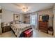Cozy bedroom with natural light, a neutral color palette and tile flooring for easy maintenance at 2457 E Del Webb Blvd, Sun City Center, FL 33573