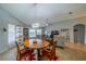 Inviting dining area with a wooden table, chandelier, and view of the living room and backyard through large windows at 2457 E Del Webb Blvd, Sun City Center, FL 33573