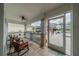 Inviting front porch with tiled flooring, seating, and a decorative screen door, perfect for relaxing and enjoying the outdoors at 2457 E Del Webb Blvd, Sun City Center, FL 33573