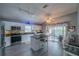 Modern kitchen with granite countertops, stainless appliances, and a stylish central island at 2457 E Del Webb Blvd, Sun City Center, FL 33573