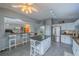Bright kitchen featuring a breakfast bar, granite counters, stainless appliances, and lots of natural light at 2457 E Del Webb Blvd, Sun City Center, FL 33573
