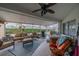 Relax in the screened lanai, complete with comfortable seating, a ceiling fan, and a hot tub at 2457 E Del Webb Blvd, Sun City Center, FL 33573