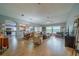 Spacious living room featuring tile floors, comfortable seating, ceiling fan, and a view of the dining area and kitchen at 2457 E Del Webb Blvd, Sun City Center, FL 33573