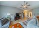 Cozy living room with comfortable seating, tile floors, a ceiling fan, and plenty of natural light at 2457 E Del Webb Blvd, Sun City Center, FL 33573