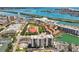 Aerial view showcasing real estate near a waterfront, with marinas and community features like green spaces at 255 Dolphin Pt # 207, Clearwater Beach, FL 33767