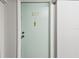 Apartment door with unit number and hardware, providing a sense of entry and security at 255 Dolphin Pt # 207, Clearwater Beach, FL 33767