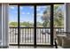 Balcony overlooking a parking area with tropical views of palm trees and blue skies at 255 Dolphin Pt # 207, Clearwater Beach, FL 33767