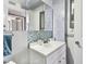 Clean bathroom with a vanity, sink, mirror, and decorative tiled backsplash at 255 Dolphin Pt # 207, Clearwater Beach, FL 33767