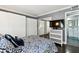 Comfortable bedroom with mirrored closet, mounted TV, and ensuite bathroom access at 255 Dolphin Pt # 207, Clearwater Beach, FL 33767