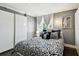 Bright bedroom with a patterned bedspread, ample natural light, and wardrobe at 255 Dolphin Pt # 207, Clearwater Beach, FL 33767