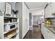 Galley kitchen featuring granite countertops, white cabinetry, mosaic tile backsplash and stainless steel sink at 255 Dolphin Pt # 207, Clearwater Beach, FL 33767