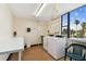 Community laundry room with washers, dryers, folding table, and window with outdoor views at 255 Dolphin Pt # 207, Clearwater Beach, FL 33767