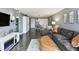 Inviting living room with a modern fireplace, TV, dining area, and comfortable sectional sofa at 255 Dolphin Pt # 207, Clearwater Beach, FL 33767