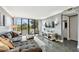 Living room showcasing a large picture window with outside views, a plush couch and grey walls at 255 Dolphin Pt # 207, Clearwater Beach, FL 33767