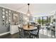 Comfortable living and dining area with chandelier, polished floors, and scenic water views at 255 Dolphin Pt # 207, Clearwater Beach, FL 33767