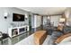 Spacious living room featuring a modern fireplace, mounted TV, and comfortable seating area at 255 Dolphin Pt # 207, Clearwater Beach, FL 33767