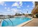Relaxing waterfront pool area with tiki hut and views of the marina, perfect for enjoying sunny days and cool breezes at 255 Dolphin Pt # 207, Clearwater Beach, FL 33767