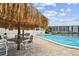 Outdoor pool with shady cabana area for relaxation and waterfront views at 255 Dolphin Pt # 207, Clearwater Beach, FL 33767