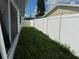 Green grass surrounds the white fence in this backyard at 2619 Albion St, Holiday, FL 34691