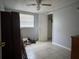 Bedroom with tiled floor, ceiling fan, and view of walk-in closet at 2619 Albion St, Holiday, FL 34691