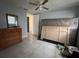 Bedroom with tan tiled flooring, ceiling fan, and wood furniture at 2619 Albion St, Holiday, FL 34691