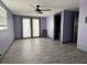 Bedroom with wood-look tile floors, french doors, and access to the bathroom at 2619 Albion St, Holiday, FL 34691