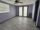 Bedroom with wood-look tile floors, french doors, and a ceiling fan at 2619 Albion St, Holiday, FL 34691