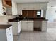 The kitchen has tile floors and fair counter space with wooden cabinets at 2619 Albion St, Holiday, FL 34691