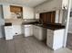 The kitchen has tile floors and fair counter space with wooden cabinets at 2619 Albion St, Holiday, FL 34691