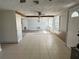 Spacious living room with tile floors and natural light from the windows at 2619 Albion St, Holiday, FL 34691
