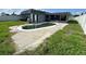 A kidney-shaped pool is the focal point of this backyard with green grass at 2619 Albion St, Holiday, FL 34691