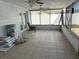Enclosed sunroom has tiled floor, multiple ceiling fans at 2619 Albion St, Holiday, FL 34691