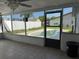 Enclosed sunroom has tiled floor, view of the pool, and a screen door at 2619 Albion St, Holiday, FL 34691