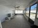 Enclosed sunroom has tiled floor, multiple ceiling fans and view of the pool at 2619 Albion St, Holiday, FL 34691