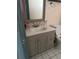 Bathroom vanity featuring granite countertop and decorative mirror at 2619 Albion St, Holiday, FL 34691