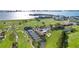 Picturesque aerial shot of a community with lush golf course, tennis courts, and waterfront views at 302 Eastleigh Dr, Belleair, FL 33756
