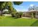 Spacious backyard featuring a brick patio, lush lawn, and well-maintained landscaping at 302 Eastleigh Dr, Belleair, FL 33756