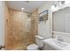Bathroom featuring tiled walk-in shower with glass surround, decorative mirror and a white vanity at 302 Eastleigh Dr, Belleair, FL 33756