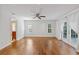 Bright bedroom with hardwood floors, recessed lighting, and French doors with sheer curtains at 302 Eastleigh Dr, Belleair, FL 33756