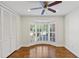 Bright bedroom with bay window and wooden shutters, ceiling fan and hardwood floors at 302 Eastleigh Dr, Belleair, FL 33756