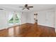 Spacious bedroom with hardwood floors, French doors, and a walk-in closet at 302 Eastleigh Dr, Belleair, FL 33756
