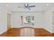 Bright dining room with hardwood floors, decorative trim, bay window with shutters and view to other rooms at 302 Eastleigh Dr, Belleair, FL 33756