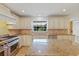 Bright kitchen with granite countertops, stainless steel appliances, and beautiful custom cabinetry at 302 Eastleigh Dr, Belleair, FL 33756