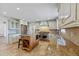 Spacious kitchen with custom island, stainless steel appliances, stone countertops, and travertine flooring at 302 Eastleigh Dr, Belleair, FL 33756