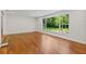 Bright living room features wood floors, large windows with backyard view, and recessed lighting at 302 Eastleigh Dr, Belleair, FL 33756