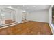 Bright and spacious living area with wood floors, recessed lighting, and archway entryway at 302 Eastleigh Dr, Belleair, FL 33756