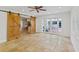 Open floor plan living room with barn doors, travertine floors, and French door to the outside at 302 Eastleigh Dr, Belleair, FL 33756